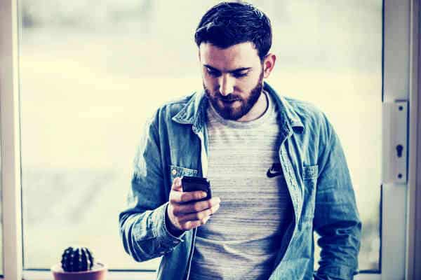 guy checking on phone alone