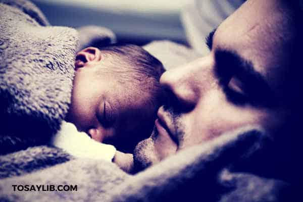 father holding baby sleep
