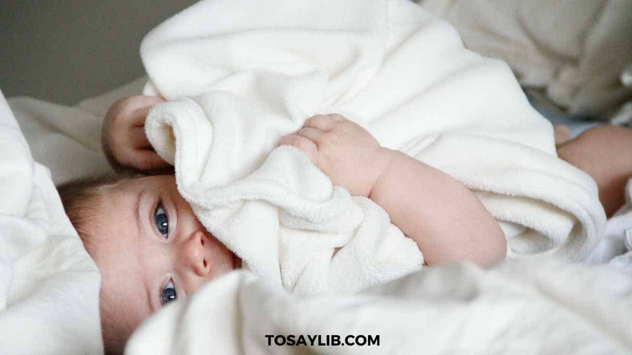 lovely baby rolling in the bed