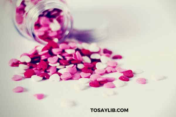bottle of pills in heart shape pink red