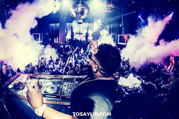 DJ waving in the club smoke