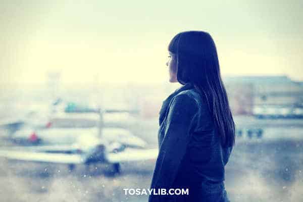 girl looking at aircrafts at airport