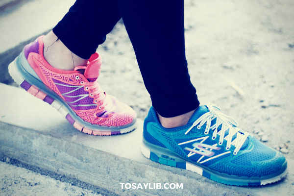 girl wearing sneakers in different colors