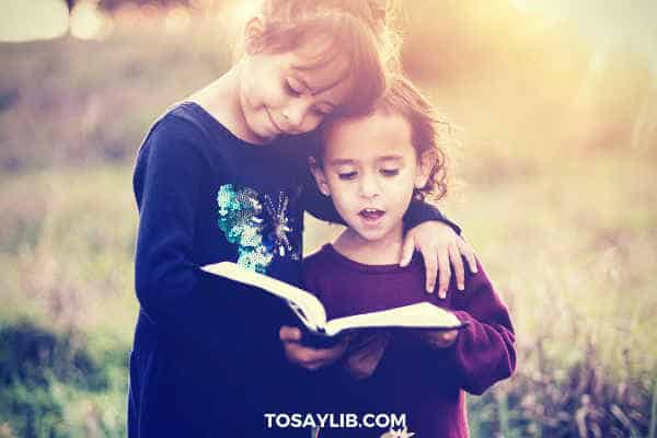 two little girls reading books