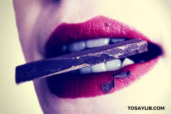 sexy lips biting a piece of chocolate