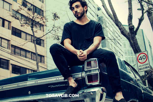 upset guy sitting on his car roof