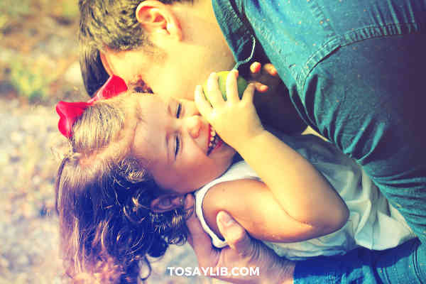 dad kissing hugging playing with daughter