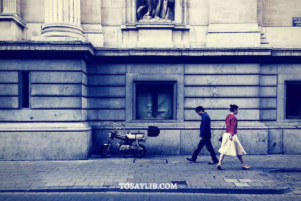 man woman walking opposite way