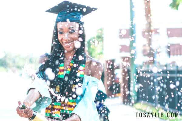 woman graduation popping wine bottle celebration