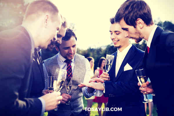 best men group discussing drinking laughing