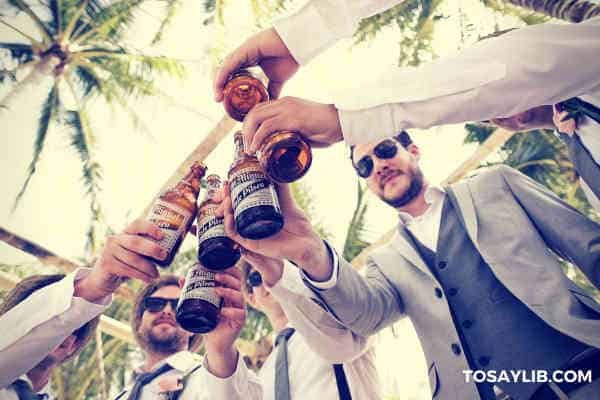 best men toasting drinking beer