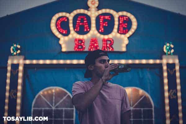 07 Man standing outside a bar drinking beer