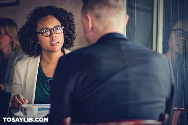 01 woman looking upset in front a man in a coffeeshop