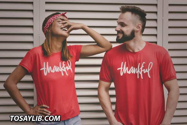 Photo of a couple wearing red shirts that says Thankful