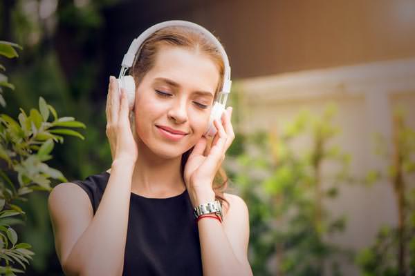 14-Featured-Woman-calmly-listening-to-music-from-her-headset