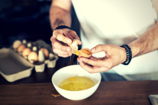 16-feature-man-white-shirt-break-eggs-eggwhite-wooden-table