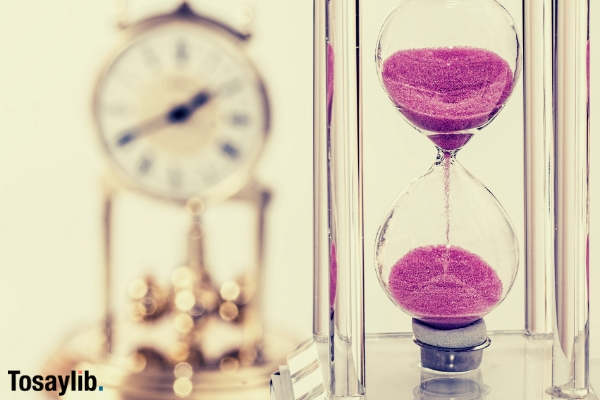 hourglass pink sand dripping clock blur background