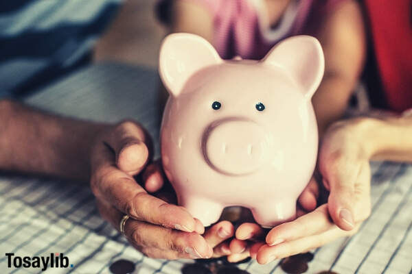 03 person holding pink piggy coin bank