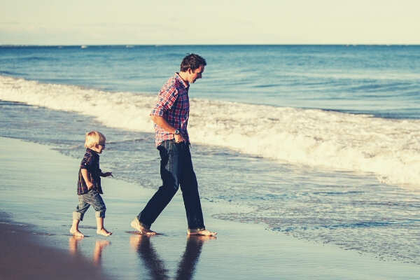 feature-Father-son-chasing-waves-sea-sky
