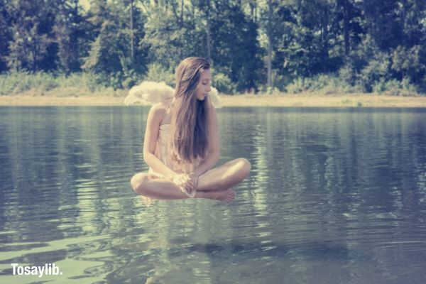 girl woman floating above a body of water