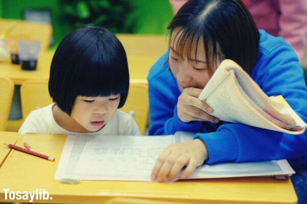 little girl student listening to her teacher 1