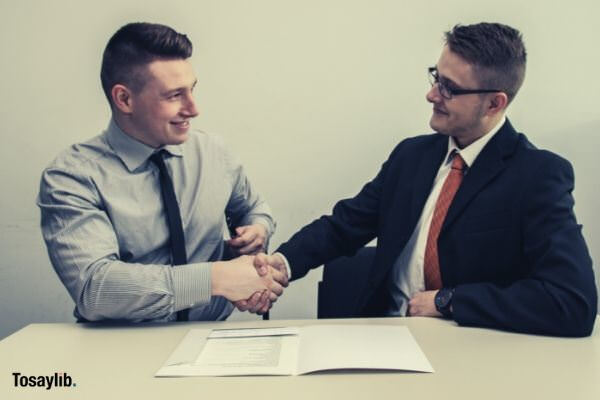 two men shaking hands formal smiling