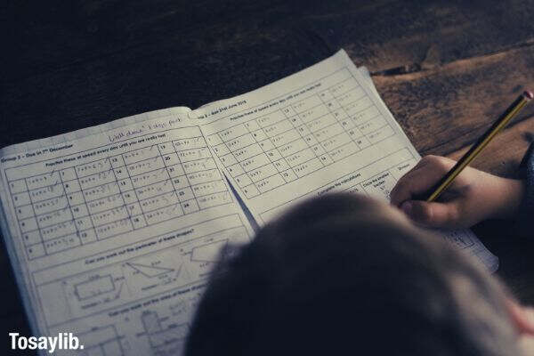 child completing math homework