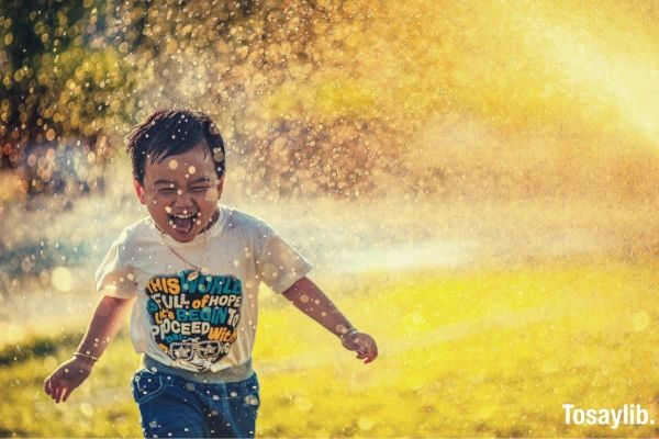 boy kid spray water happy