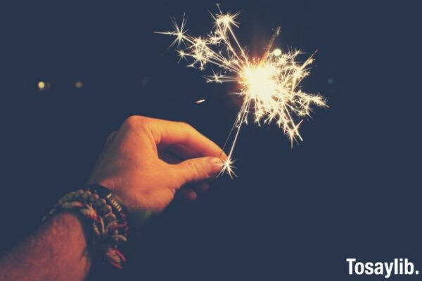 photo of person holding sparkler