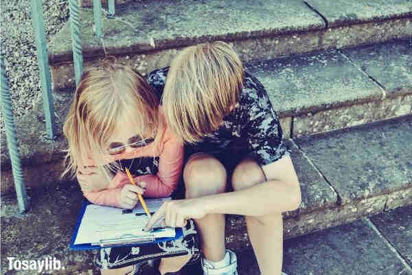 boy teaching girl kid