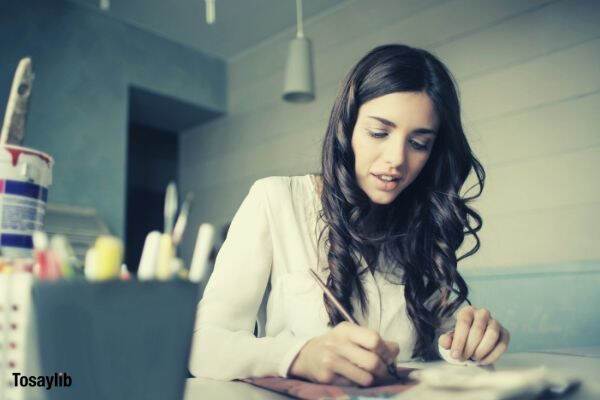 05 woman sitting while holding pen