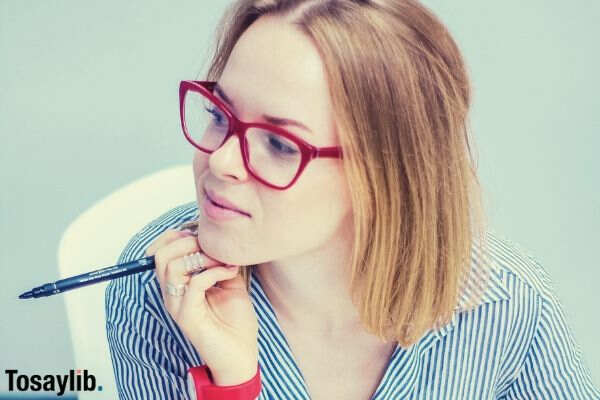 photo of woman with red eyeglass holding pen 1