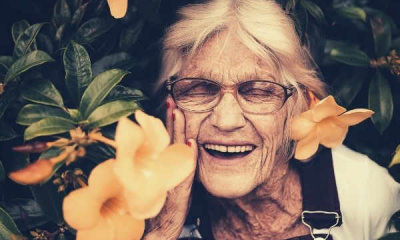 woman-standing-near-yellow-petaled-flower