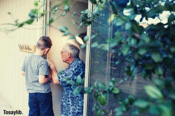 grandpa and grandson working together to fix and repair a sliding door at home