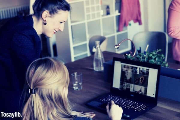 two women looking laptop working