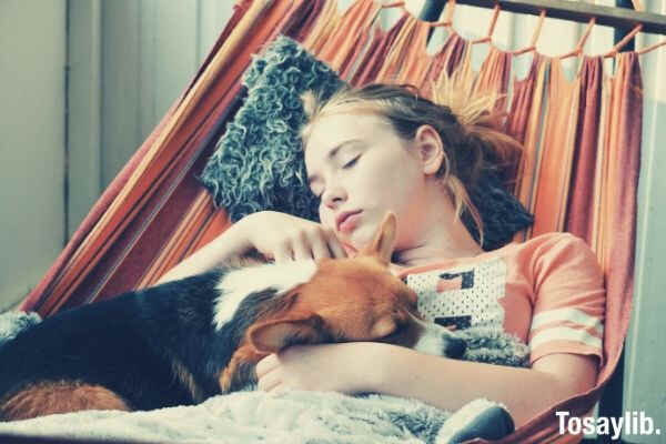 girl and her dog sleeping in the hammock