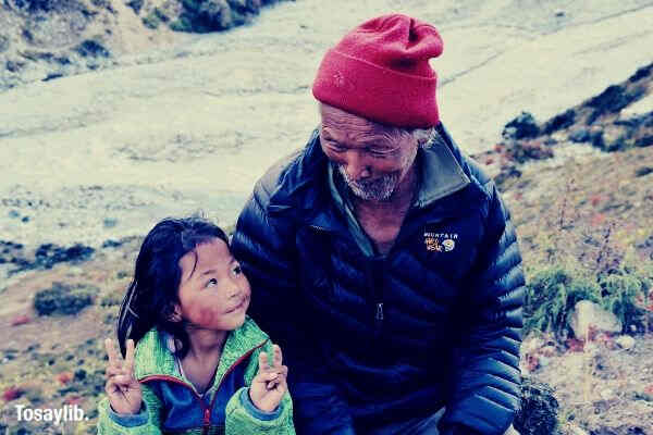 grand father and little girl laughing in nepal