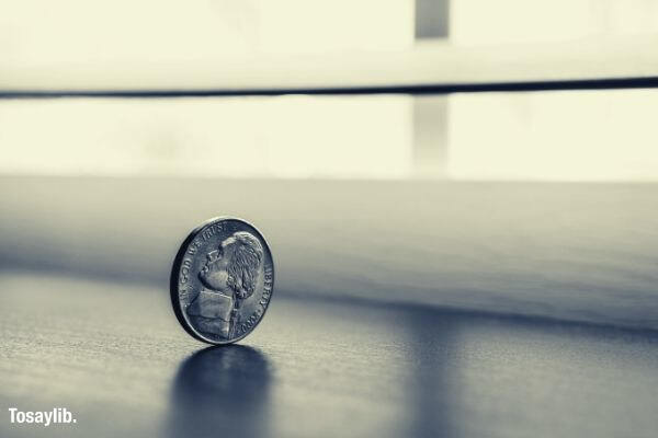 monochrome photography of round silver coin
