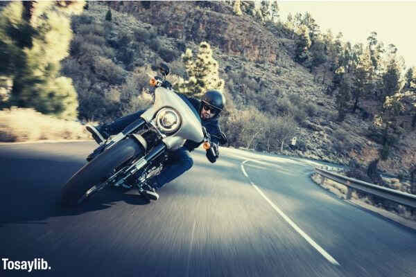 man motorcycle vehicle road