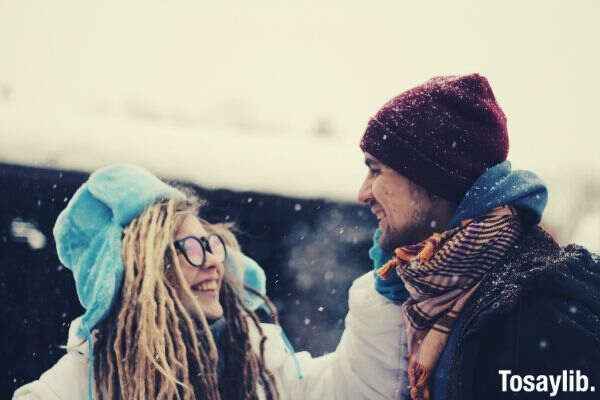 couple smiling snow