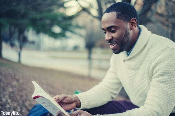 black american long sleeves reading book