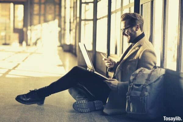 formal guy sitting and leaning on the wall