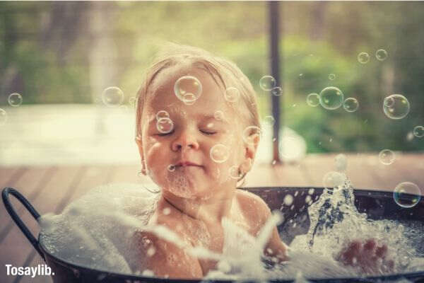 boy taking a bath bubbles