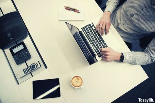 man in formal long sleeves using laptop