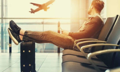 man-sitting-travel-plane-luggage-bag