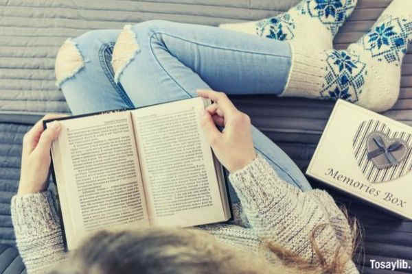 girl reading book wearing socks