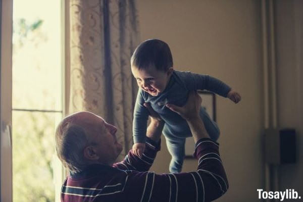 grandpa lifting baby