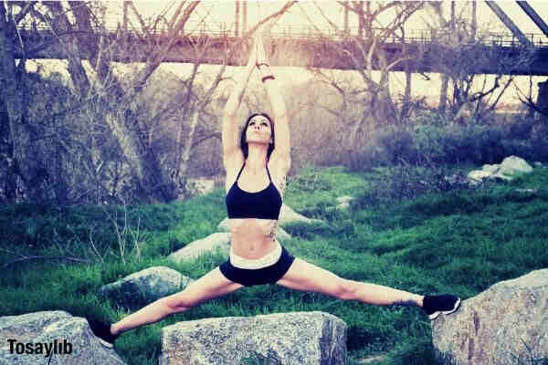 woman yoga fitness nature grass trees rock