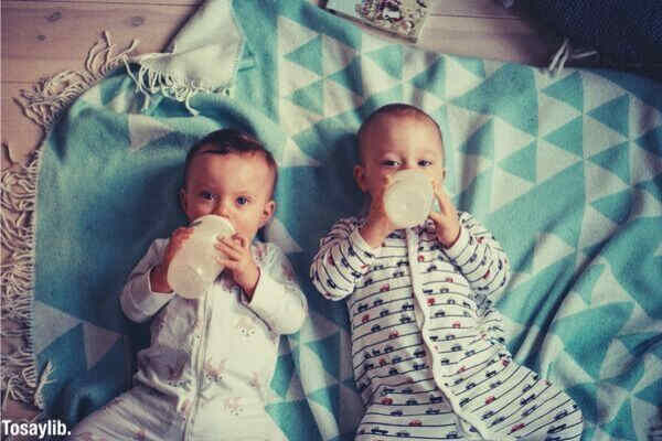 babies drinking feeding bottle