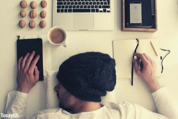 students using computers sleeping man